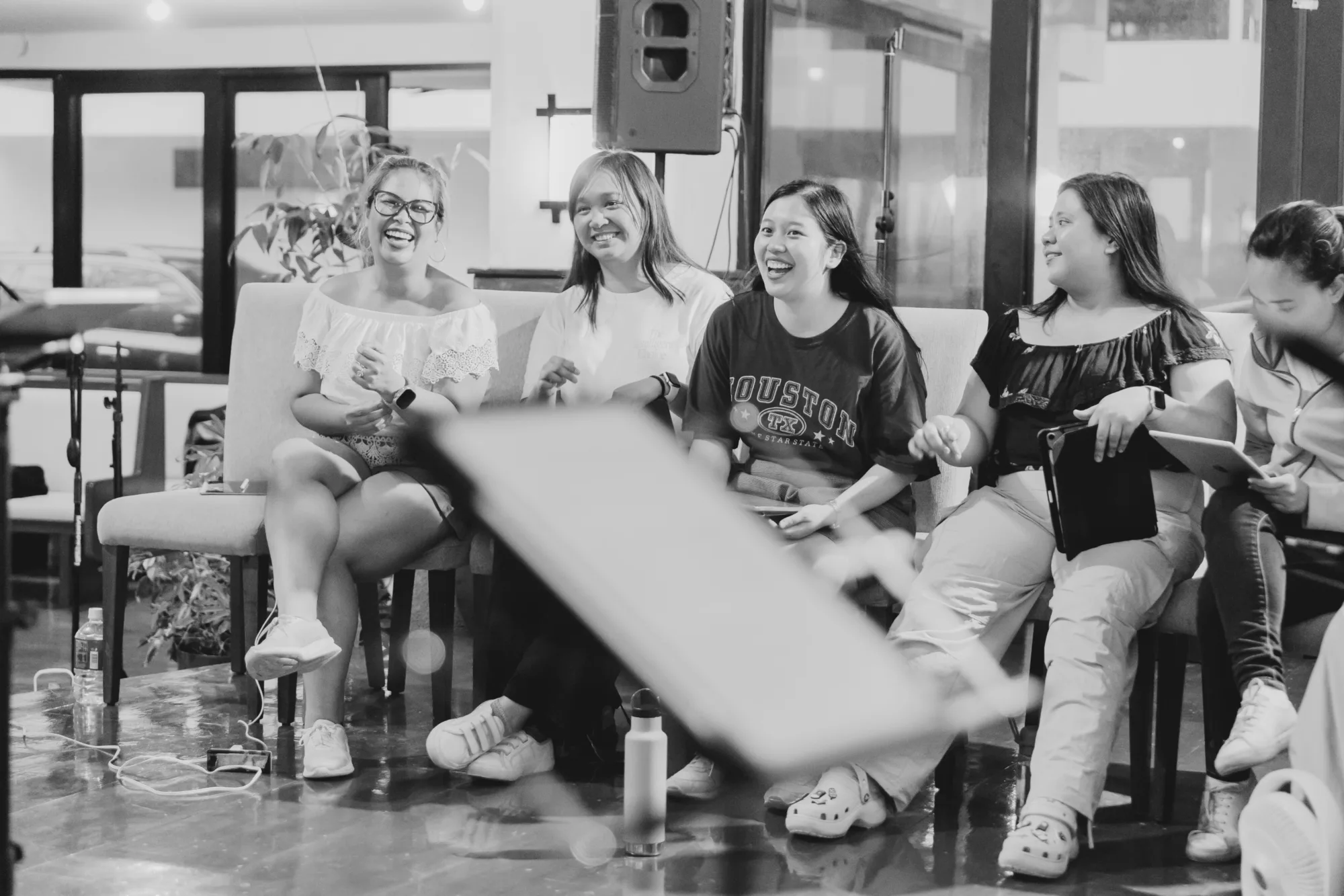 Choir members laughing together during a relaxed rehearsal
